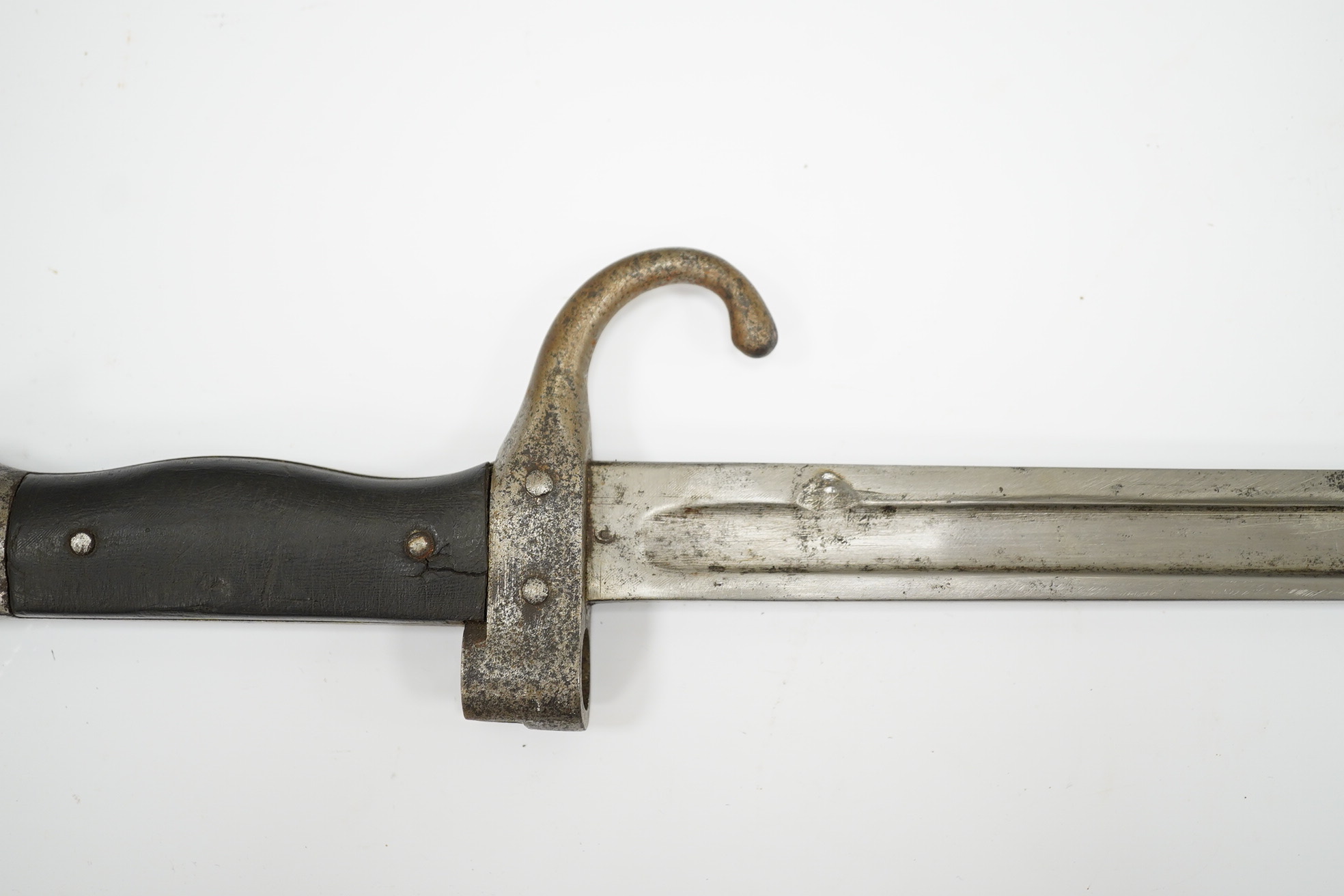 A 19th century French infantryman’s sidearm Gladius with swollen double edged blade, and regulation cast brass cruciform hilt, in its brass mounted leather scabbard, together with a continental bayonet also in scabbard.